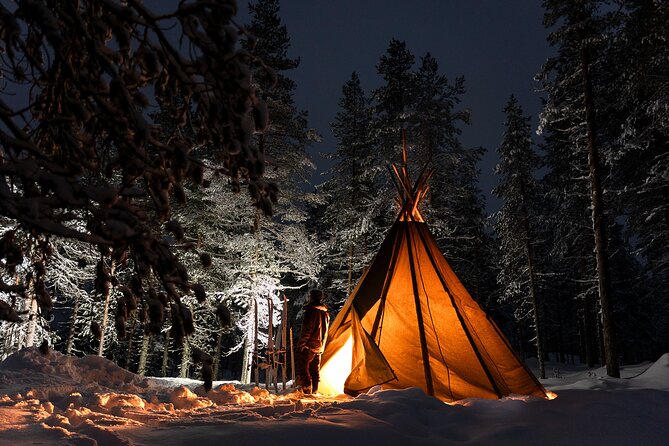 Evening Ski Trek to the Wilderness - Extra Small group - The kota stop: fire, grilled snack, and reindeer-skin comfort