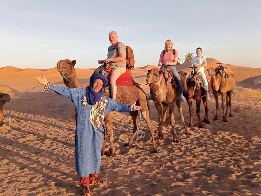 From Merzouga: Overnight Camel Trek over Erg Chebbi Dunes - Day 1 on the Dunes: Sunset Camel Ride, Sandboarding, and Tagine by Fire